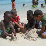 Ricardo, Leuri, Son and David building sand sculptures.