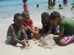 Ricardo, Leuri, Son and David building sand sculptures.