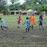Cakito avoids getting knocked over by zealous soccer players.