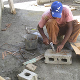 Abe straightens out used nails so they can be used again.