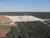 Mine infrastructure area with clearing of mine truck access road (upper centre).