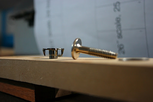 Here, you can see the stainless steel prongs on the T-nuts, which prevent the nut from spinning as the bolt is torqued. The large flange delivers tremendous downward pressure, maximizing contact between the mating wood surfaces of the neck joint.