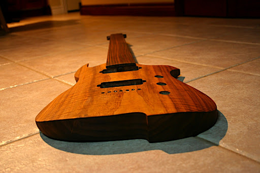 This isn't a carved top in the tradition of an stringed instrument or an archtop guitar. It's more of a "radius" or "arc" top.