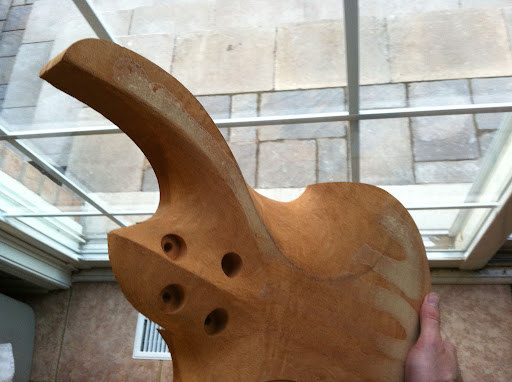 The front of the guitar is meant to look clean and precise, like a surgical instrument. The back is more organic, with lines and organic curves suggesting structure under a fluid skin.