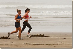 Two female joggers on foggy Morro Strand State Beach