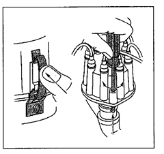 Fasten the cap to the housing either by pressing on the center of the cap spring, forcing the spring over the mounting lugs on the cap (left), or by pressing down on the screw and turning it until the clamp is underthe slot on the bottom  of the housing (right). 
