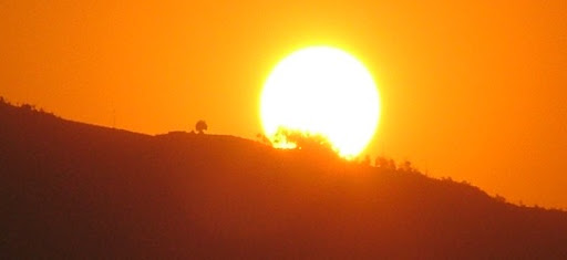 the setting sun over the hills of kaski