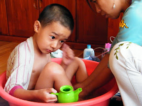 baby with his toys in bath.