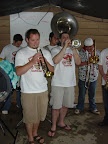 Photo: The Kingpin Brass Band plays their first set under the tent to avoid the rain.