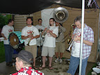 Photo: Kingpin Brass Band finishes out their set under the tent.