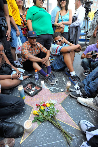 LOS ANGELES, CA - JUNE 25: Fans of pop star Michael Jackson sit vigil at talk radio host Michael Jackson's Star on the Hollywood Walk of Fame mourning his death on June 25, 2009 in Los Angeles, California. Jackson, 50, the iconic pop star, died after going into cardiac arrest in a hospital today in Los Angeles, California. (Photo by Charley Gallay/Getty Images)