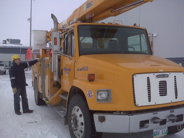 Ryan visually inspecting a bucket truck.