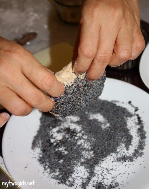 Coating the dough in poppy seeds