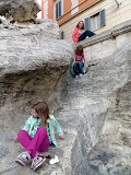 The girls ignore the sign, hop the fence and climb down the back way of Trevi Fountain.