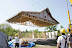 The completed roof is craned onto the prefabricated straw bale wall panels