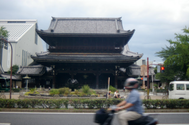 Kyoto temple w/ moped driver in foreground
