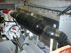 This Stainless Steel Exhaust riser built by National Marine Exhaust is installed on a Cummins M-11 in a 52' Meridian Yacht. Picture is taken before the deck is installed. A white cloth insulation / lagging kit is installed on the hot exhaust pipe connecte