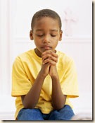 black boy praying eyes closed