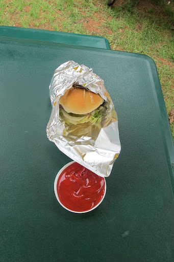 An impromptu ketchup bowl is created to accompany a burger.