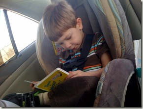 Aaron reading with his leg crossed