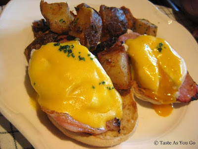Classic Eggs Benedict with Canadian Bacon and Hollandaise on a Muffin and Herb Roasted Potatoes at The Standard Grill in New York, NY - Photo by Taste As You Go