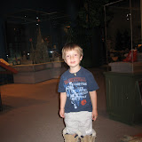 Erik tries on some big boots in the Weather Permitting exhibit at the Minnesota History Center