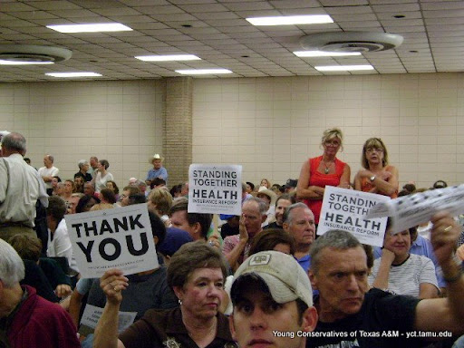 Obama supporters hold up supposedly banned printed signs