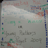 Kai's classmates signed the board congratulating him for his winning entry in the Young Authors' Project