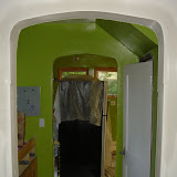 The new entryway with a layer of joint compound on it. The guys who did it messed up the curve on one side when they added a corner bead. I'm hoping I can get them to fix it.