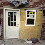 Ed and I built a wall where his garage door used to be (yes, we're going to take down the basketball hoop too)