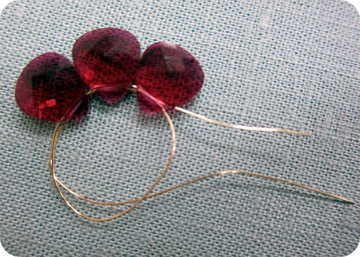 creating small flower step 1: string 3 small petal beads through 28 gauge wire, loop back around through all 3 and pull tight.