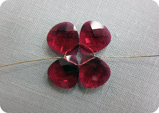 step 3: feed one end of wire through 2 petals, one at a time, so the each end of wire are opposite each other.