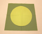 Place circle paper-side-down on top of square, lining up the folds, and press in place. The circle will temporarily stick to the square.