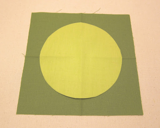 Place circle paper-side-down on top of square, lining up the folds, and press in place. The circle will temporarily stick to the square.