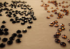 lay rhinestone on a work surface, glue side face down