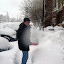 Eric scooping snow.