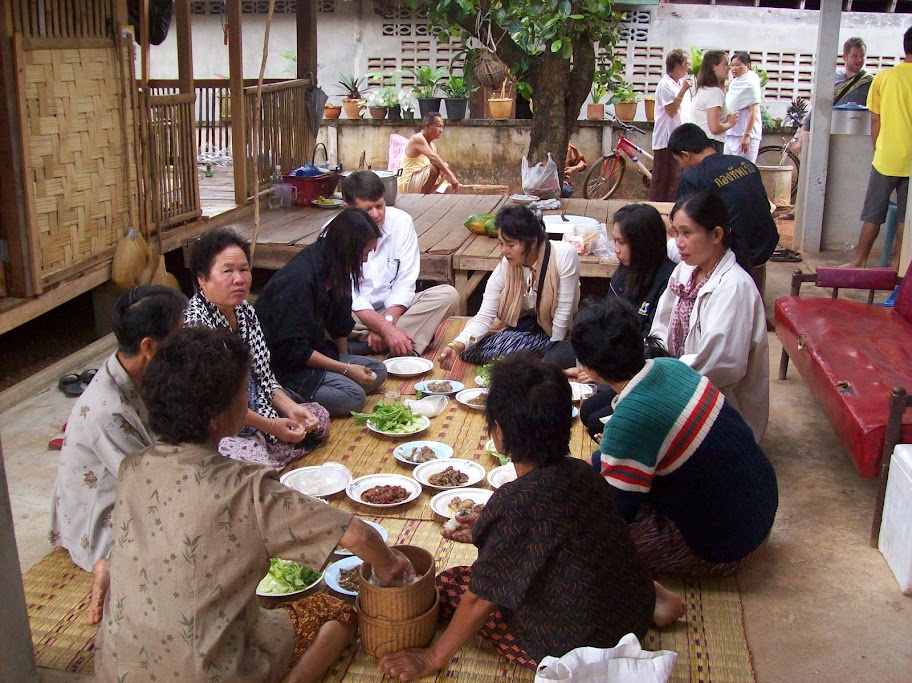 A Thai family welcome Llyod to their table for a culinary experience Lunch time.