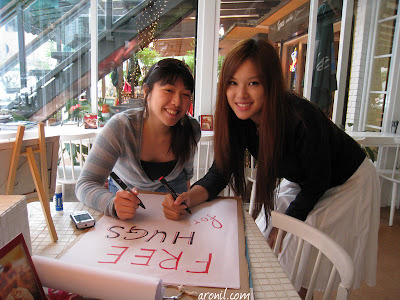Simon made the sign board that we needed. Here we are set to writing up the first sign for our board. Whats up with all the signs? The point of it is actually to carry out the plan which is "FREE HUGS AND KISSES FOR MISTER POTATO"