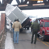 Crews assess the situation at the overpass on old 92, just outside Washington on Thursday January 14, 2009. This tractor trailer was too tall to fit under the overpass (KCII NEWS)