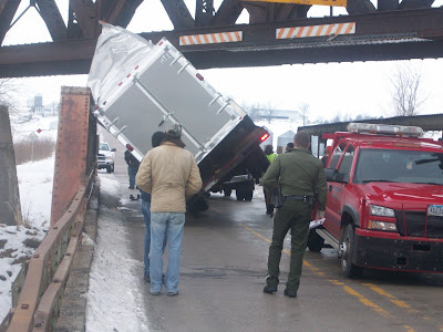 Crews assess the situation at the overpass on old 92, just outside Washington on Thursday January 14, 2009. This tractor trailer was too tall to fit under the overpass (KCII NEWS) Crews assess the situation at the overpass on old 92, just outside Washington on Thursday January 14, 2009. This tractor trailer was too tall to fit under the overpass (KCII NEWS)