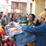 Shantha aunty distributing blanket and biscuit
