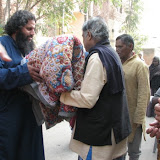 Maitreya distributing blanket and biscuit