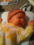 Just before changing. Incidentally, this one of my favorite outfits of hers because it's cute and also easy for me to change the diaper. Yellow is more or less becoming her color and I think it looks good on her.