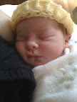 Audrey resting. The hat was a gift from the hospital. They have a group of women who make knitted hats to go home with all of the newborns.