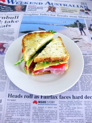 sandwich on plate on newspaper