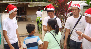 MCCID Santa Clauses greet the parents and kids on their way home.
