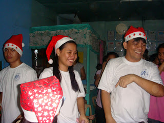 Sir Jojo introduces the MCCID Student Santa Clauses Joanna, Moises and Jepa.