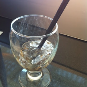 a glass with ice and a straw