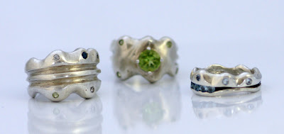 Three Bottleneck Rings set with three stones setting techniques. Sterling silver, white topaz, sapphire, peridot, aquamarine.