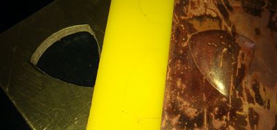 16 ga brass and 2 pieces of tempered masonite cut into shield silhouette die by Pat Accorinti Yellow urethane sheet 24 ga copper sheet pressed in 20 ton hydraulic press